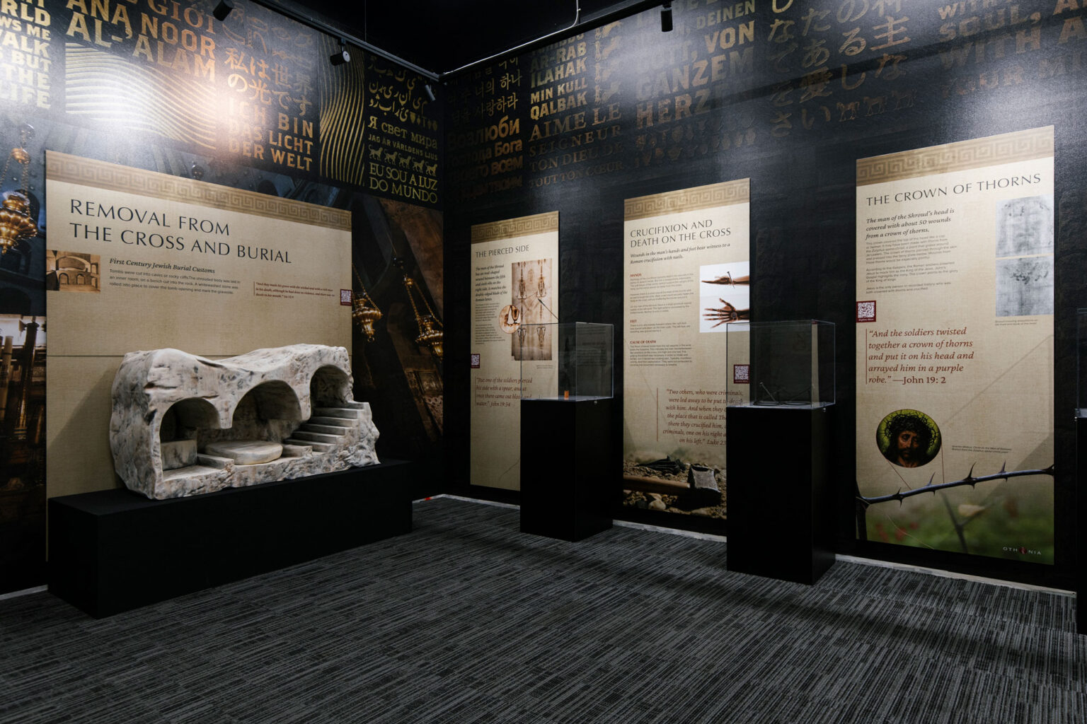 Museum gallery with panels on the Passion and a replica of the tomb