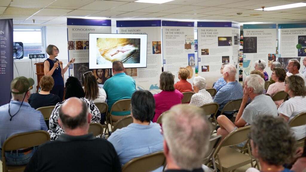 A full room listening to a presentation at the Shroud exhibit