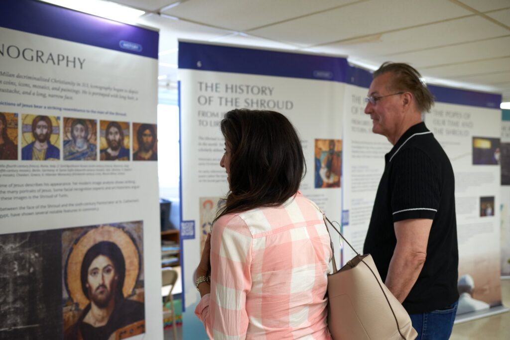 Visitors reading the iconography and history panels at the exhibit